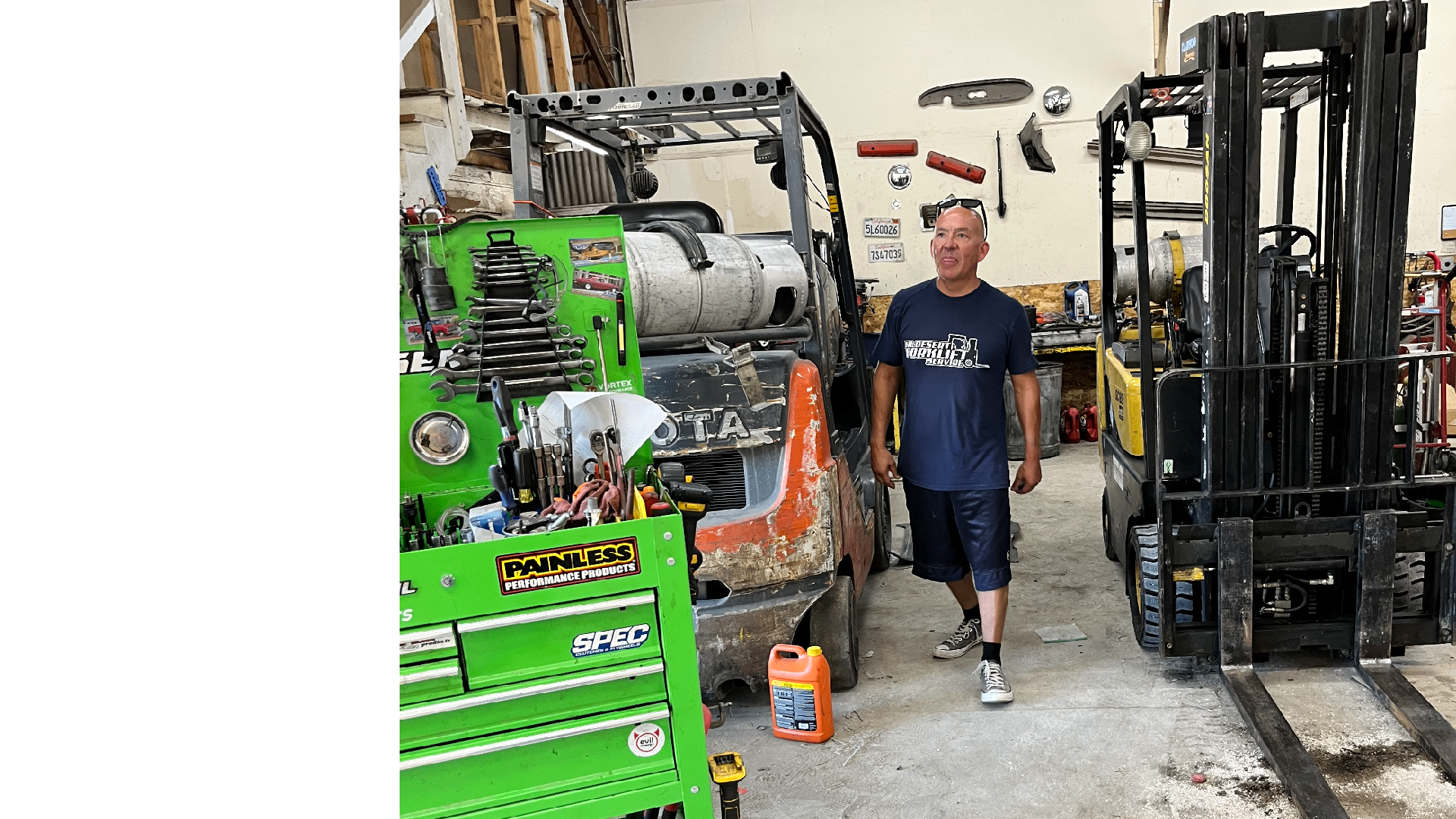 Hi Desert Forklift owner standing in the service shop between forklifts in Victorville, CA