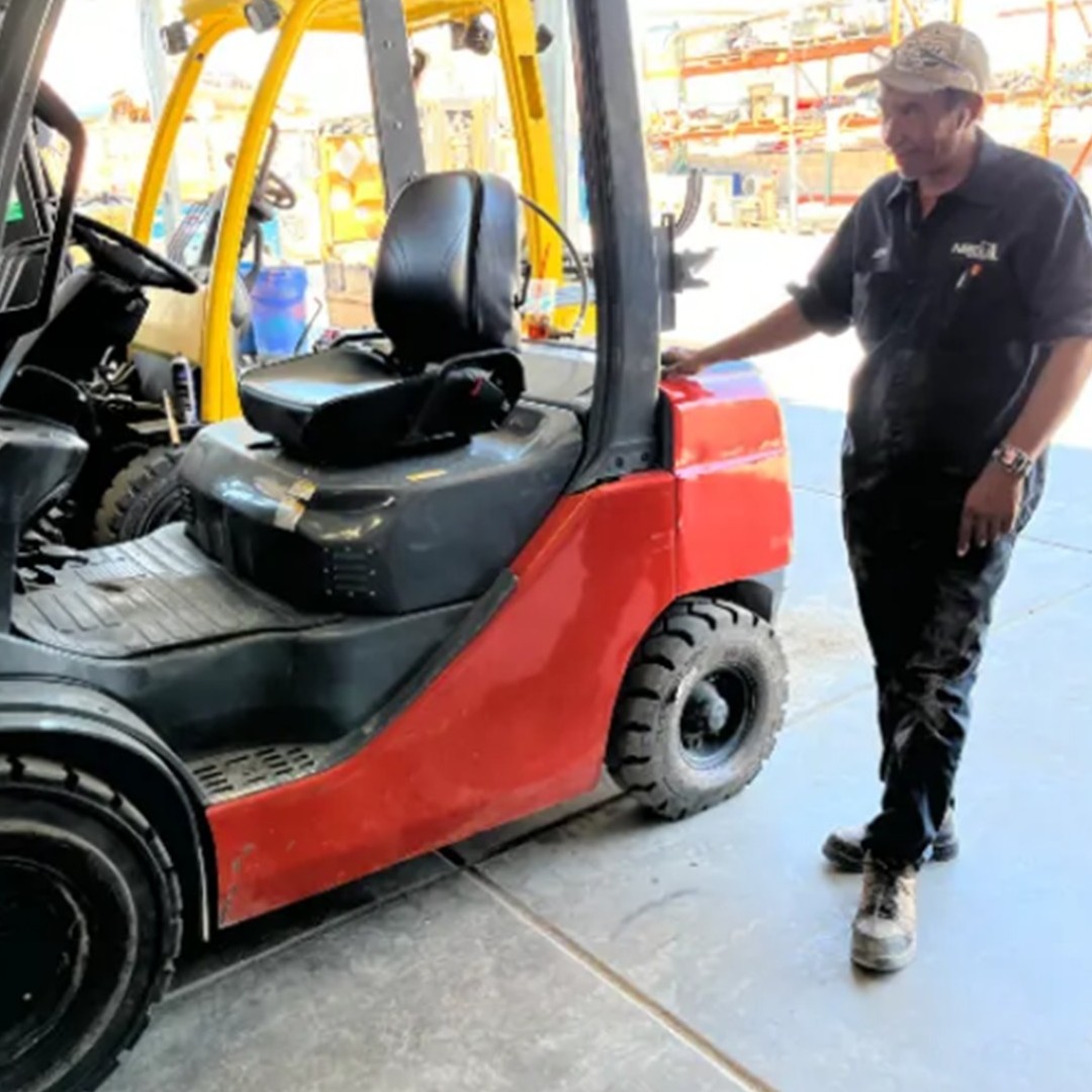 Hi Desert Forklift foreman standing next to a reconditioned used forklift